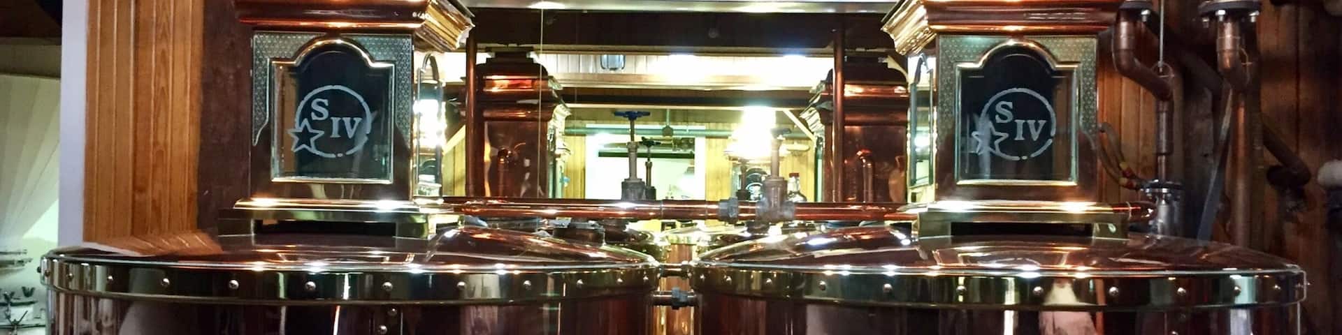 The distillation tanks inside the cook house.