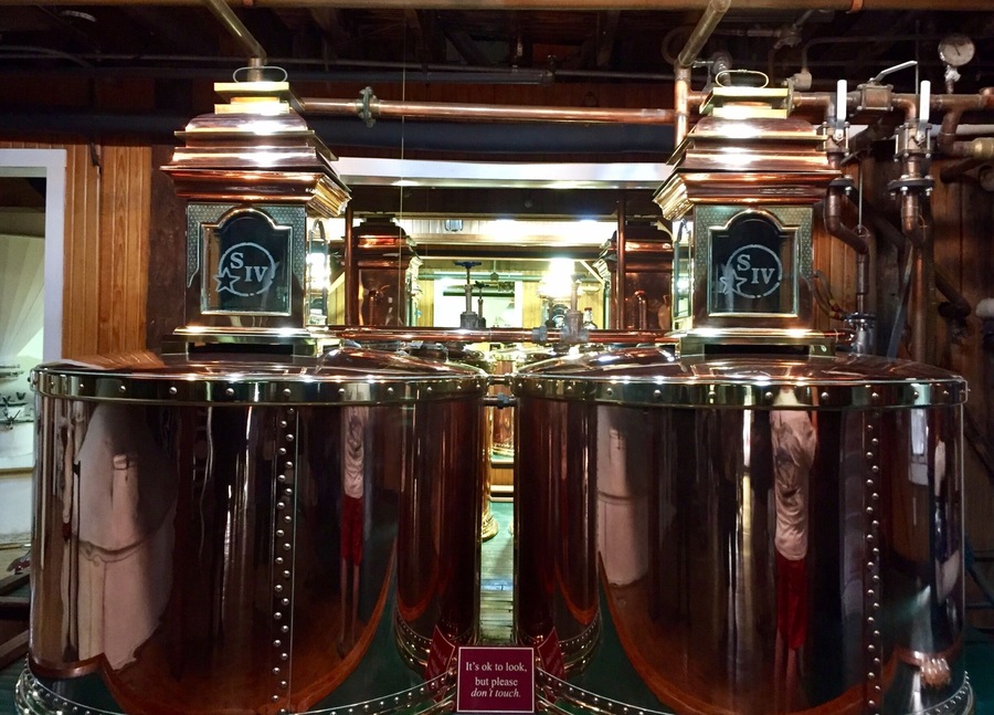 The distillation tanks inside the cook house.