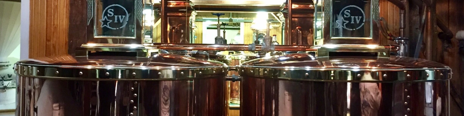 The distillation tanks inside the cook house.
