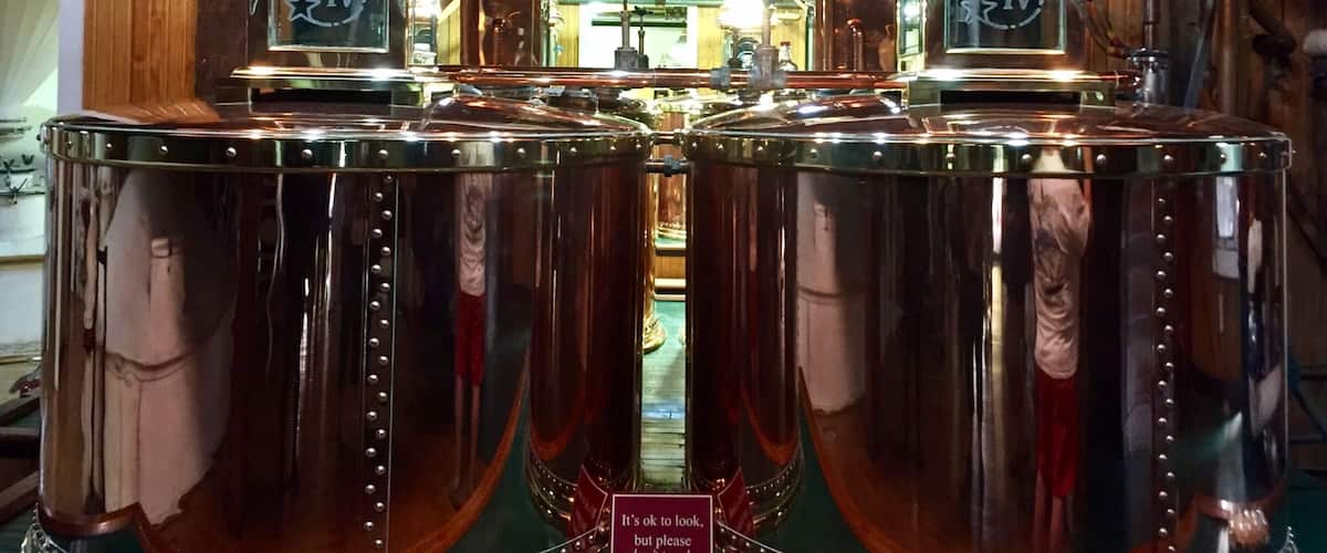 The distillation tanks inside the cook house.
