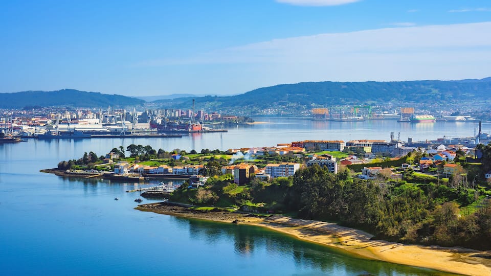 A coastal city with a bay, residential areas, and industrial buildings.