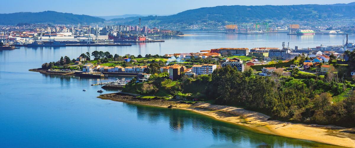 A coastal city with a bay, residential areas, and industrial buildings.