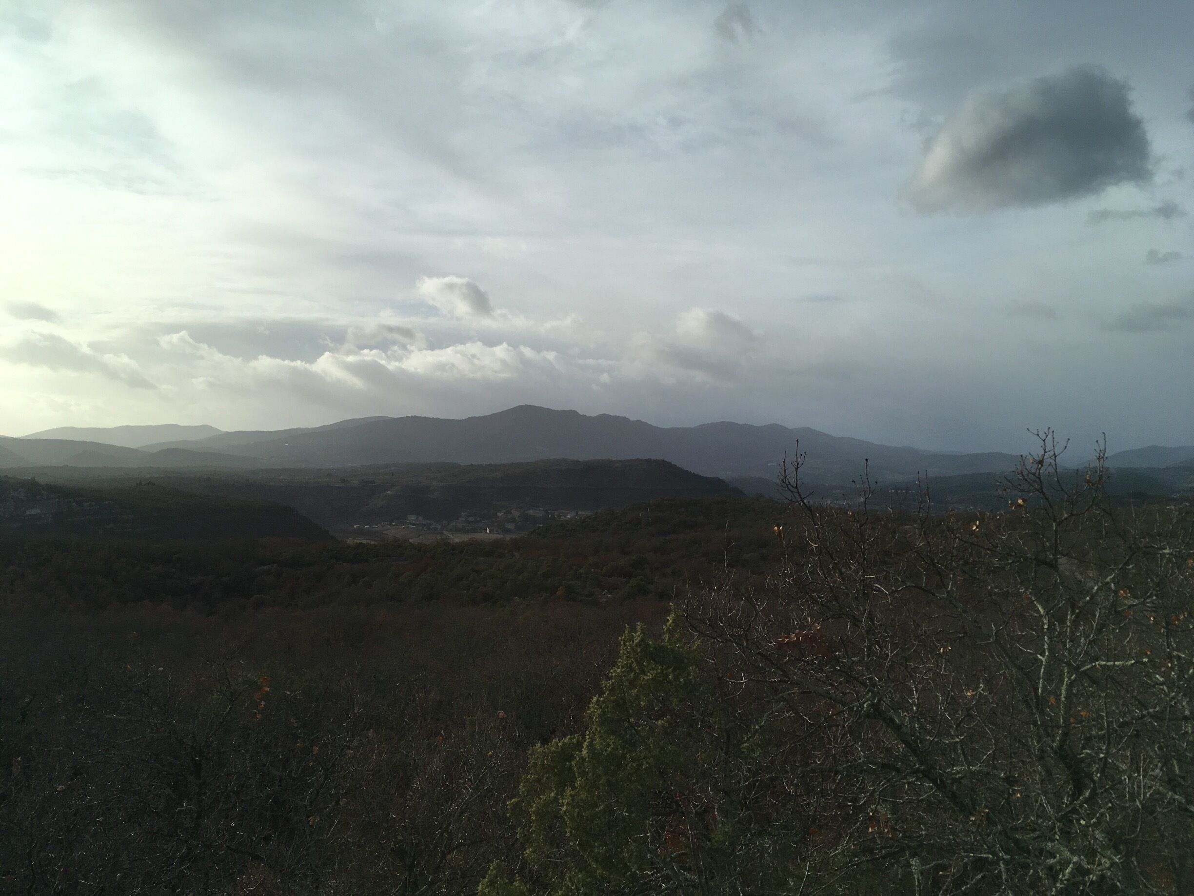 A mountainous landscape with a cloudy sky.