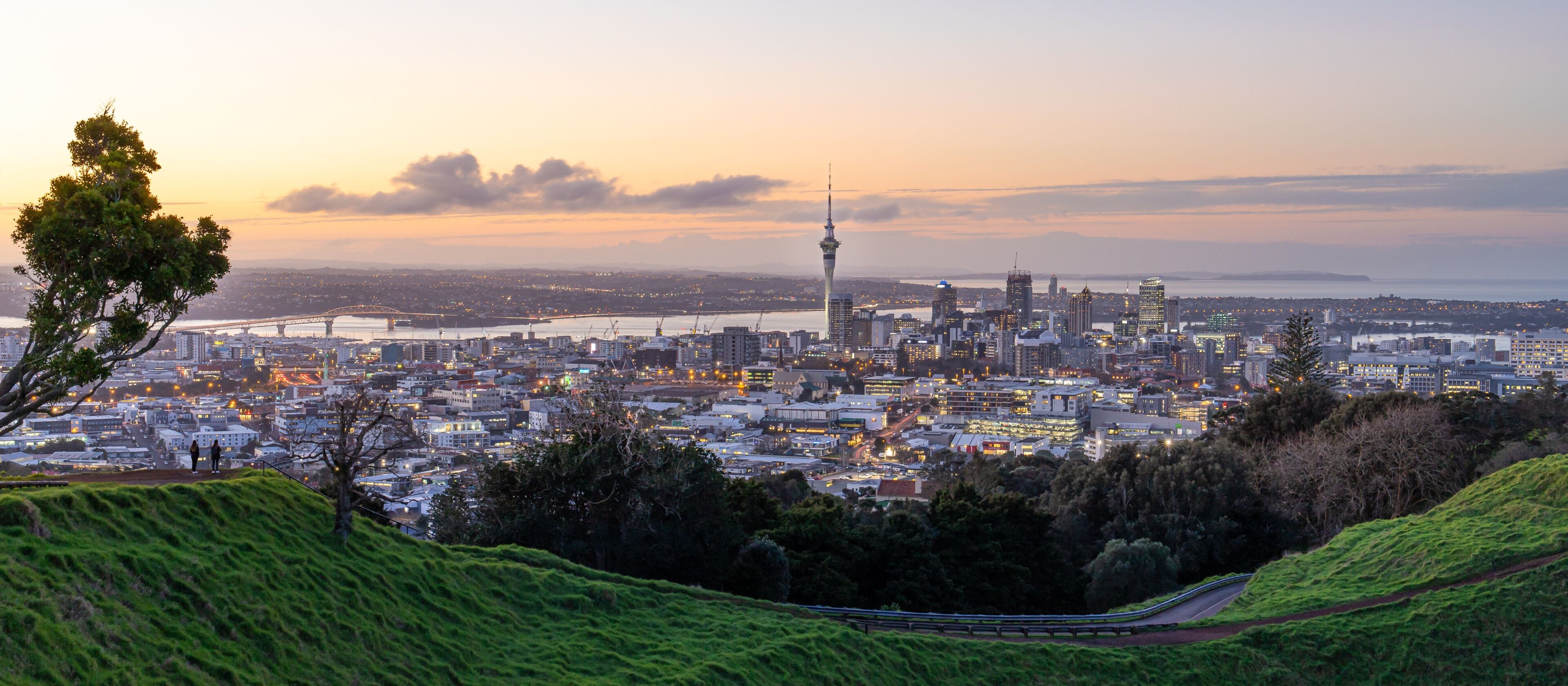 Auckland city skyline with Auckland Sky Tower from Mt. Eden at sunset New Zealand