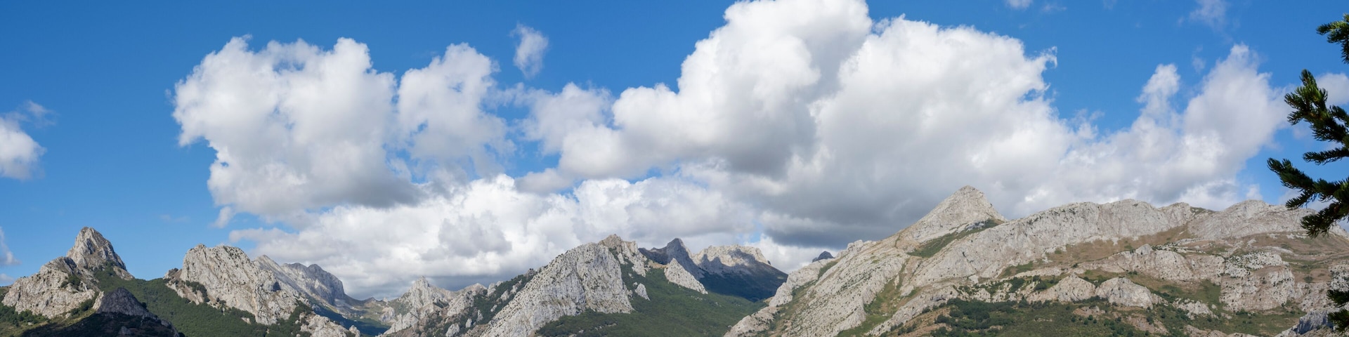 A mountainous landscape with a lake and clear blue sky.