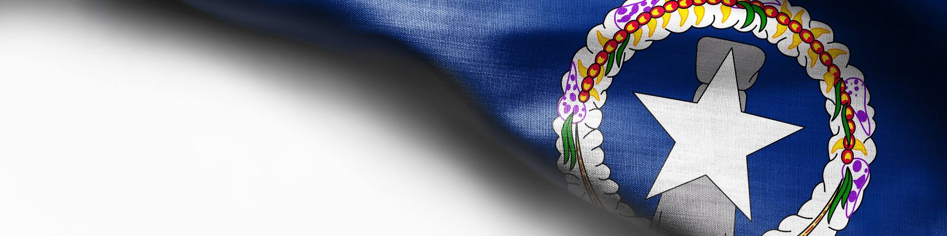A flag with a white star and a circular emblem with colorful beads.