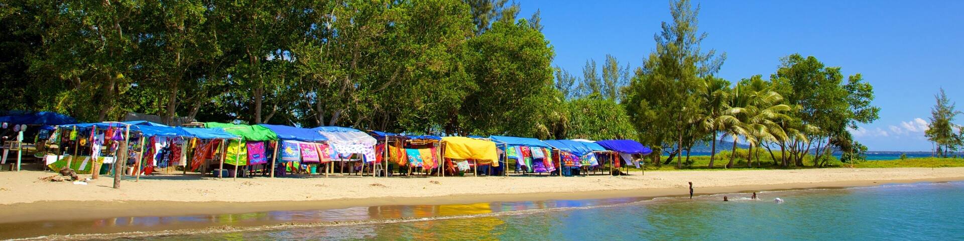 Mele Bay which includes a sandy beach and tropical scenes