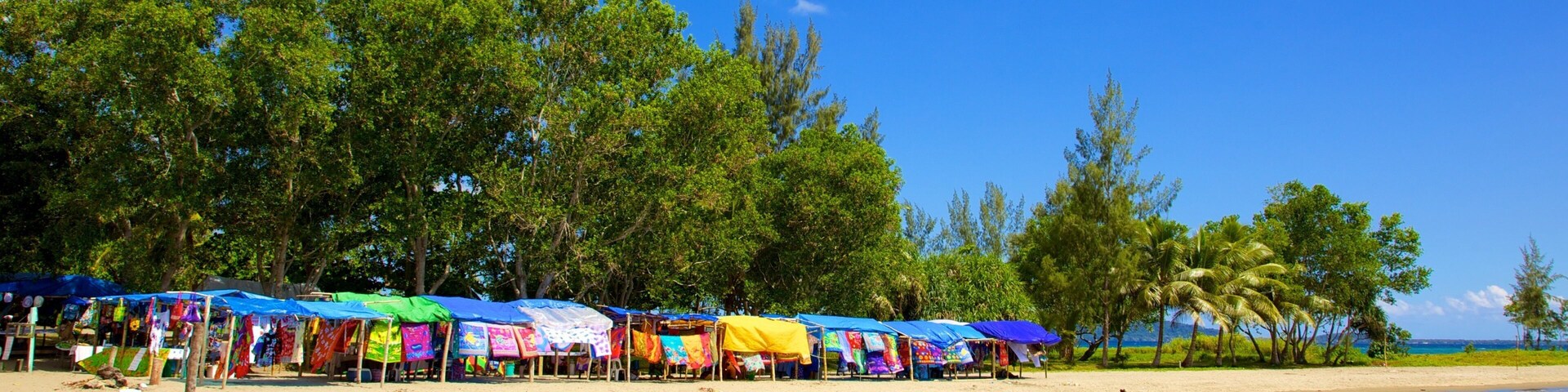 Mele Bay which includes a sandy beach and tropical scenes