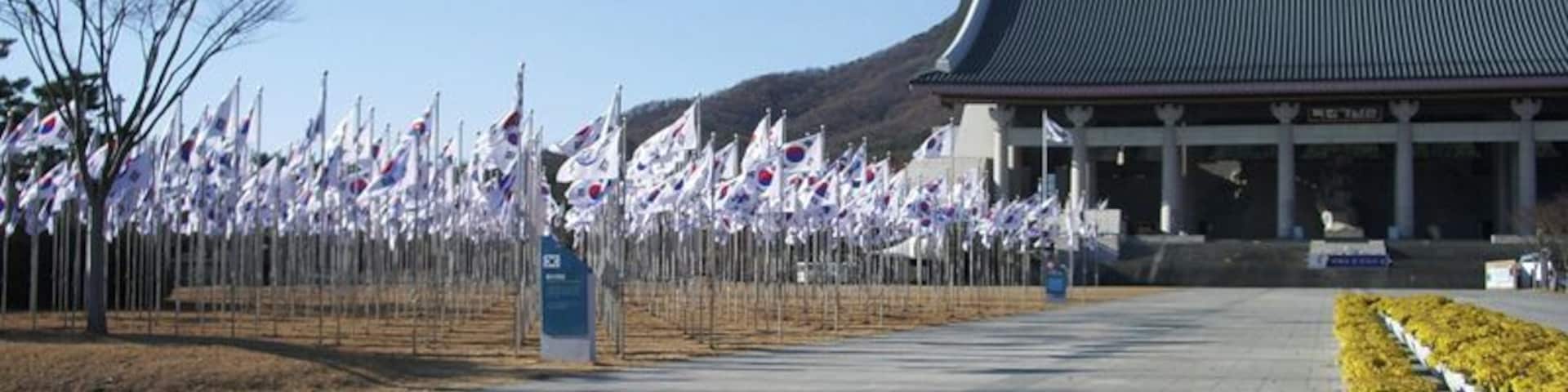 Closing in on the main hall. Now I see 815 flagpoles of varying heights, displaying the national flag. Quite a sight. Of course, 815 is a significant number because it marks August 15th; on that date in 1945, Japan surrendered to the Allies to end World War II, and per the provisions of Potsdam Declaration, Japan's rule over Korea ended. However, the euphoria was short lived, as the Soviets, who had entered the war against Japan only six days before, were busy marching into northern Korea already, and the US hastily proposed dividing Korea at the 38th Parallel for a split Soviet-American trusteeship rule until the mess could be sorted out. Three years later, on August 15th, 1948, the Republic of Korea was proclaimed. However, due to continuing Soviet-American disagreements, the UN-monitored elections for the first Republic of Korea government were limited to the American sector, and the Republic of Korea ended up only being the southern government. By September 9th of the same year, Democratic People's Republic of Korea was set up in the Soviet sector, and Korea was permanently divided.