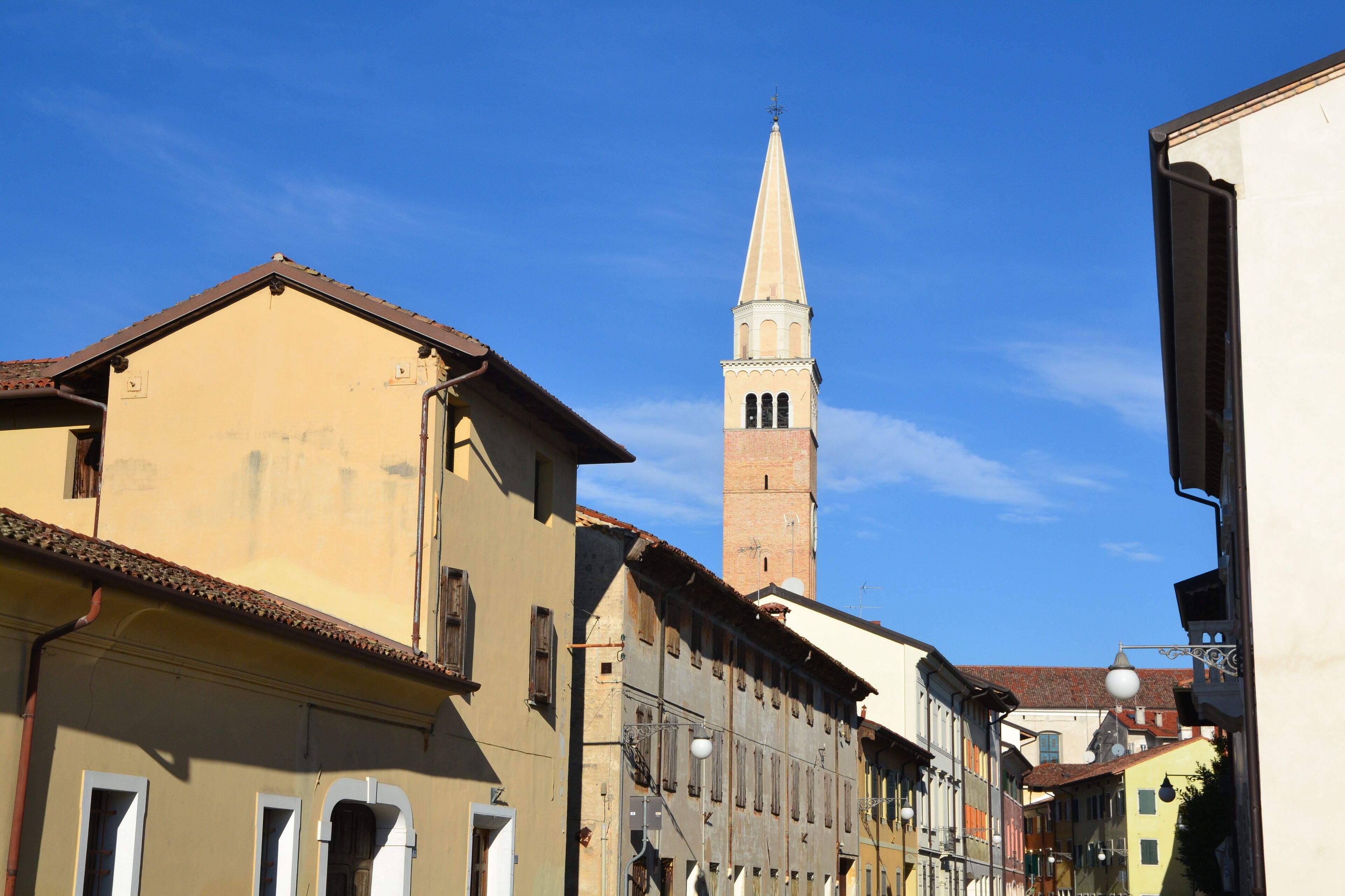 A historic town with a prominent church tower and traditional buildings.