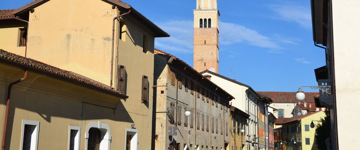 A historic town with a prominent church tower and traditional buildings.