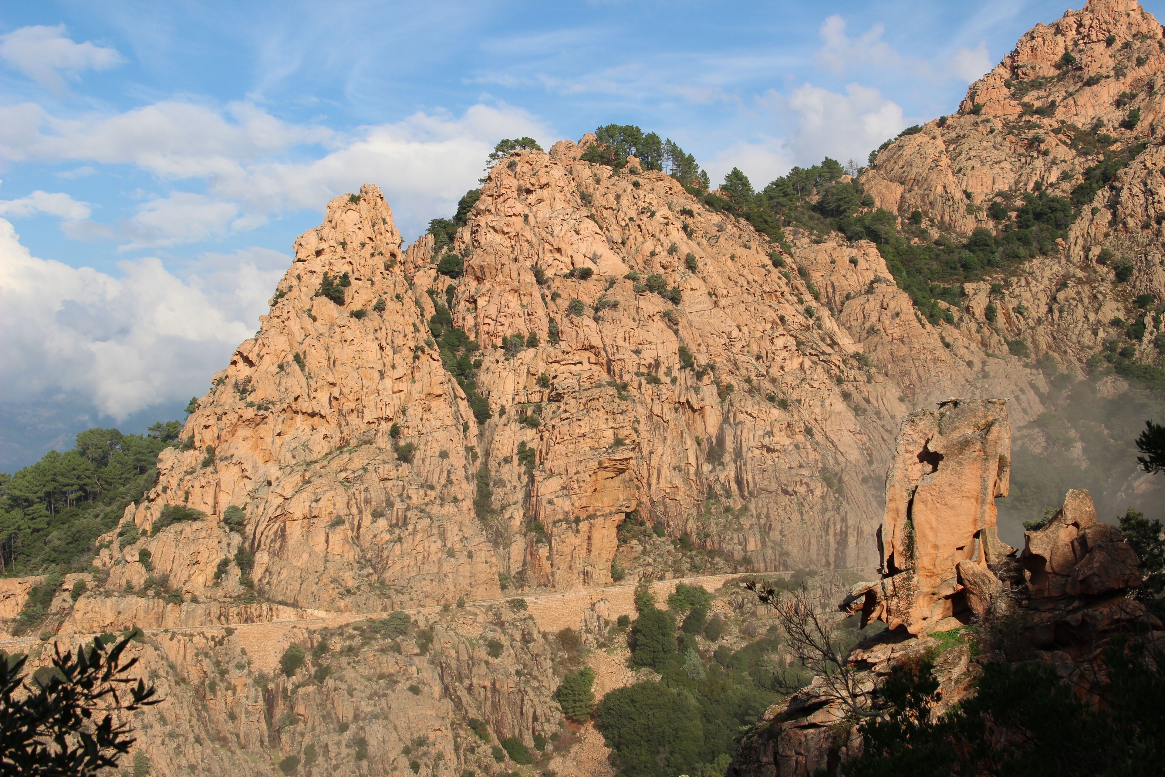 Rugged mountains with rocky cliffs and sparse vegetation.