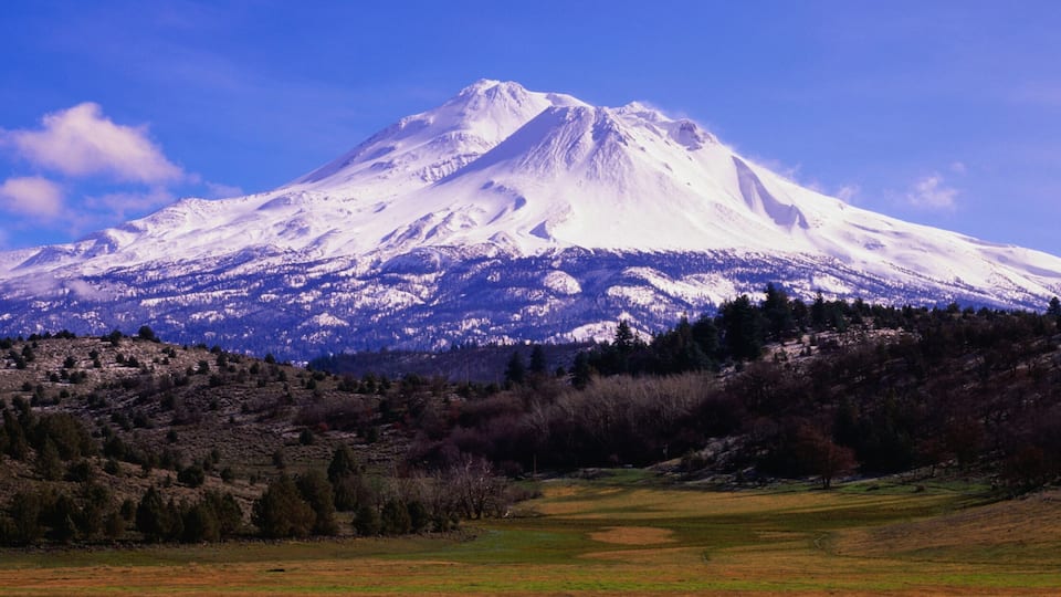 A snow-capped mountain with a clear sky.