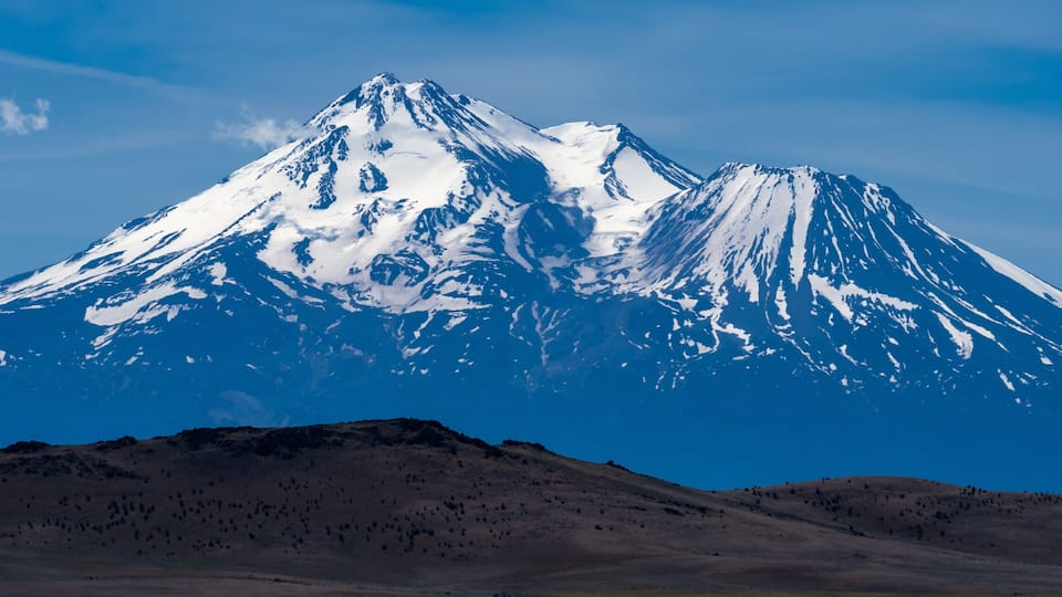 A snow-capped mountain with a clear sky.