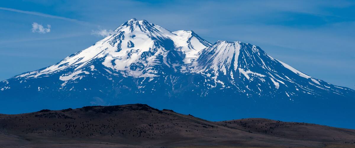 A snow-capped mountain with a clear sky.