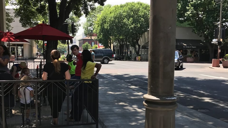 A street scene with pedestrians, a red umbrella, and a storefront named "Ice Cream & Yogurt."