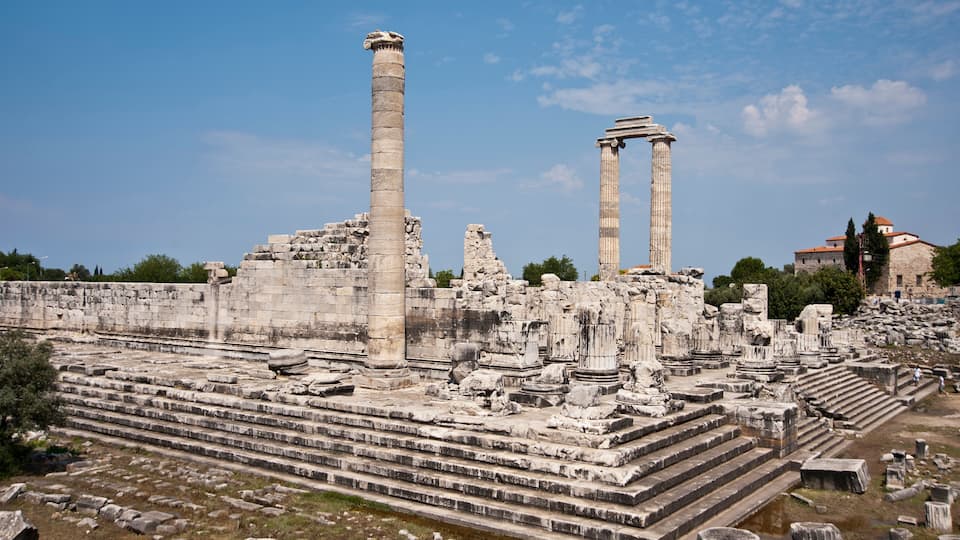 Ancient ruins with columns and steps.