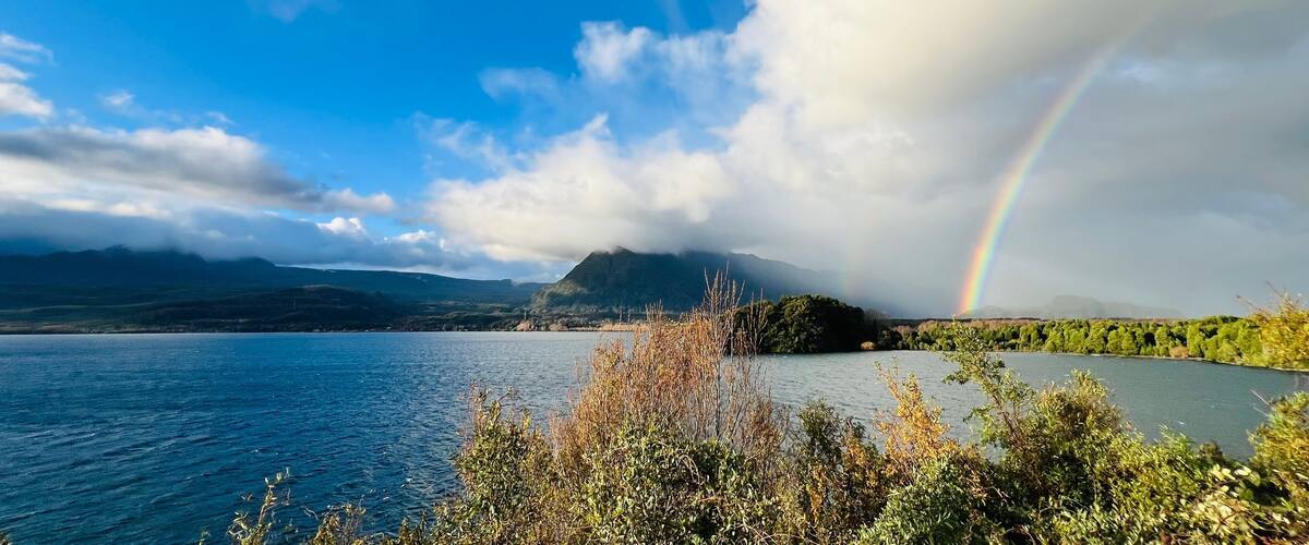 A lake, mountains, and a rainbow.