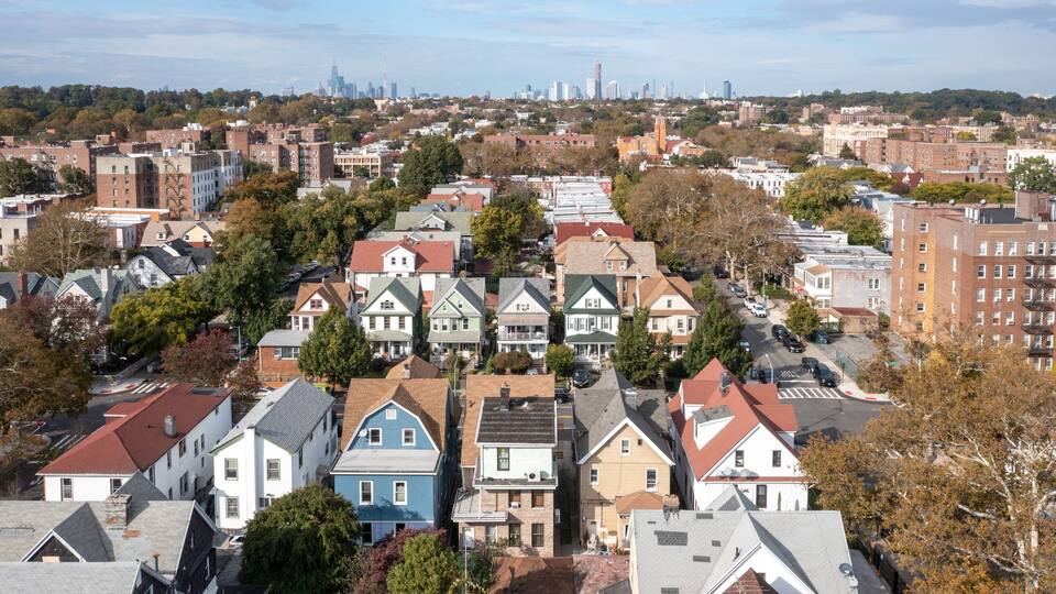 A densely packed urban neighborhood with a variety of residential buildings, including houses and apartment complexes.