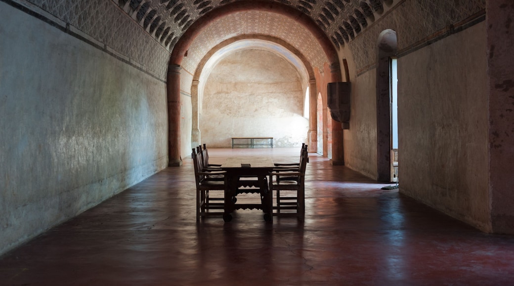 Single tables and chairs inside the cloister at Actopan Mexico