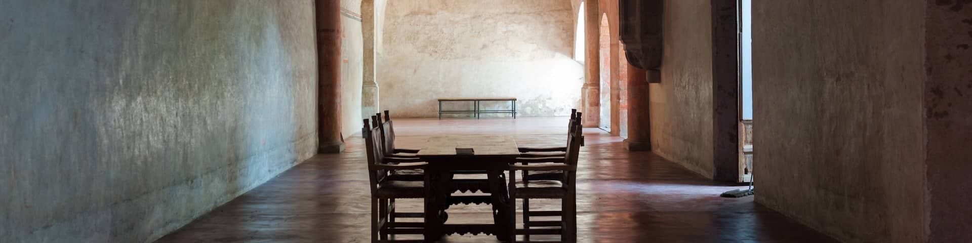 Single tables and chairs inside the cloister at Actopan Mexico