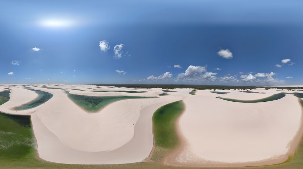 360 aerial photo taken with drone of border of western side of Lençóis Maranhenses and mangue at midday on the northern coast of Brazil
