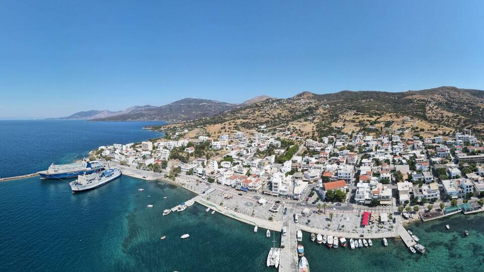 A coastal town with a marina, boats, and buildings.