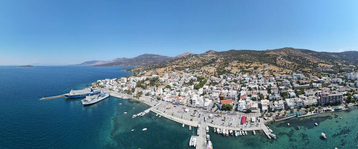A coastal town with a marina, boats, and buildings.
