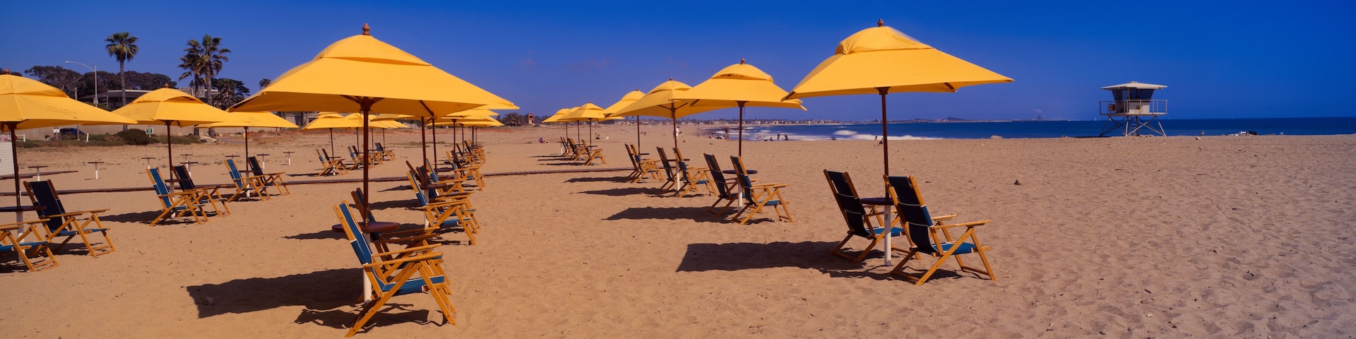 Yellow umbrellas and beach chairs on Ventura beach, California