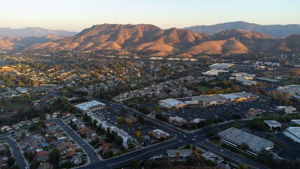 A cityscape with mountains in the background.