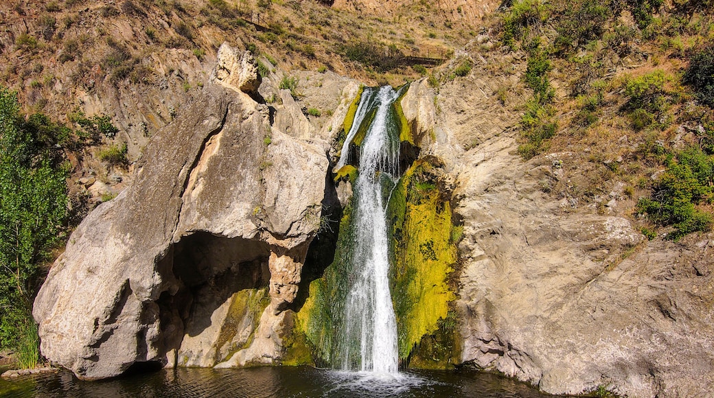 a stunning aerial shot of the waterfall covered in green and yellow algae and the surrounded mountain landscape at Paradise Falls in Thousand Oaks California USA