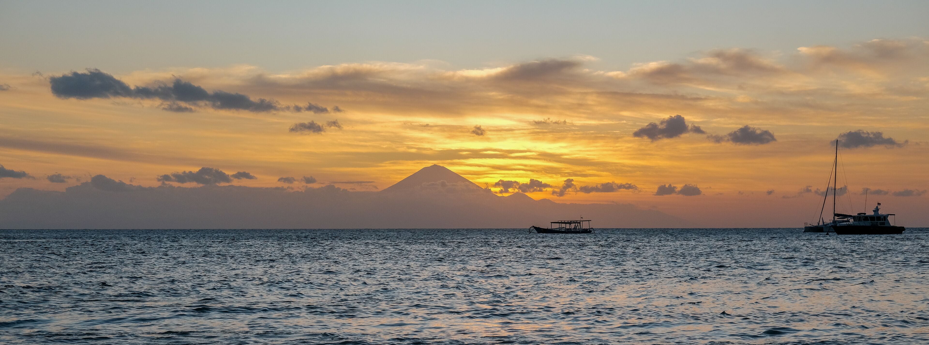 sunset view on senggigi lombok beach with the silhouette of mount agung bali, sunset over the sea, sunset at the beach, sunset and mountain, lighthouse at sea