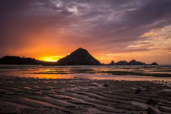 Sunrise with a low tide could create some very neat pictures. I was too late to take advantage of getting closer to the people out gathering the different types of seafood left stranded by the low water.