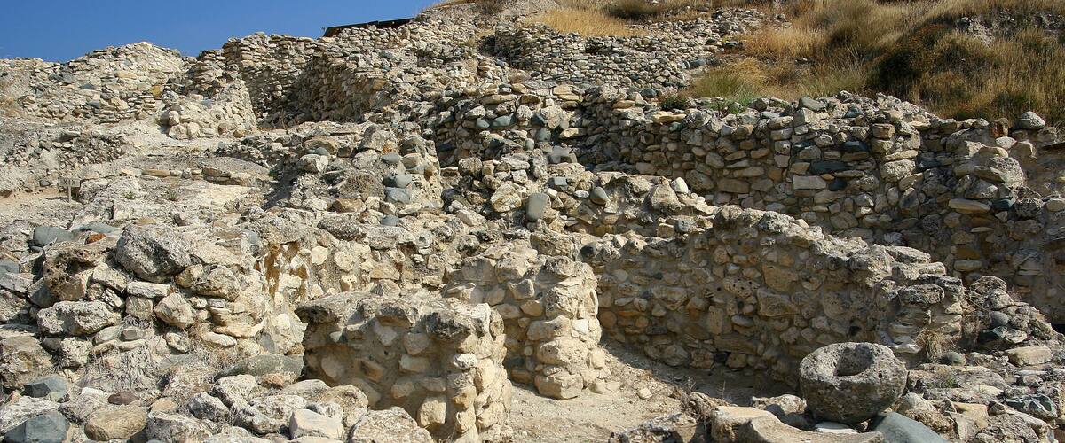 Ancient stone ruins with irregular walls and scattered stones.