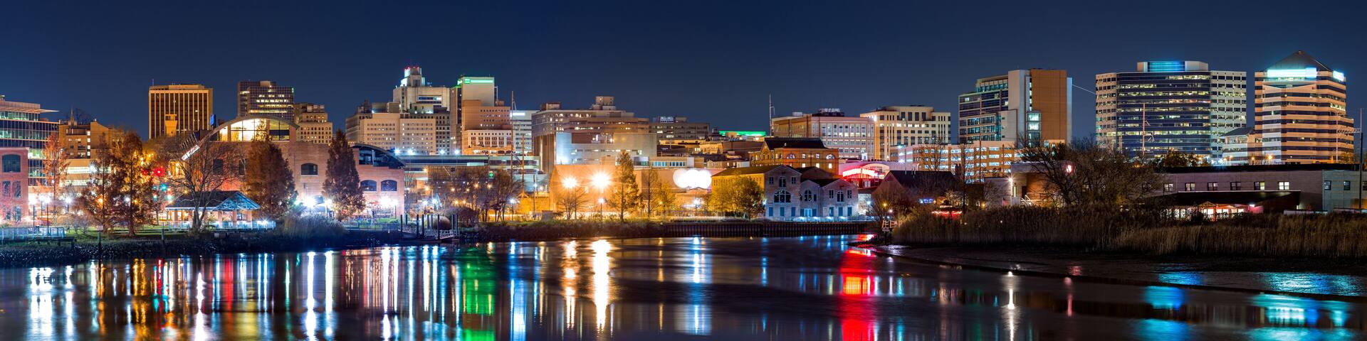 Wilmington skyline panorama reflected in Christiana River. Wilmington, the largest city in the state of Delaware, is built on the site of Fort Christina, the first Swedish settlement in North America