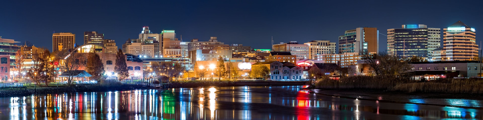 Wilmington skyline panorama reflected in Christiana River. Wilmington, the largest city in the state of Delaware, is built on the site of Fort Christina, the first Swedish settlement in North America