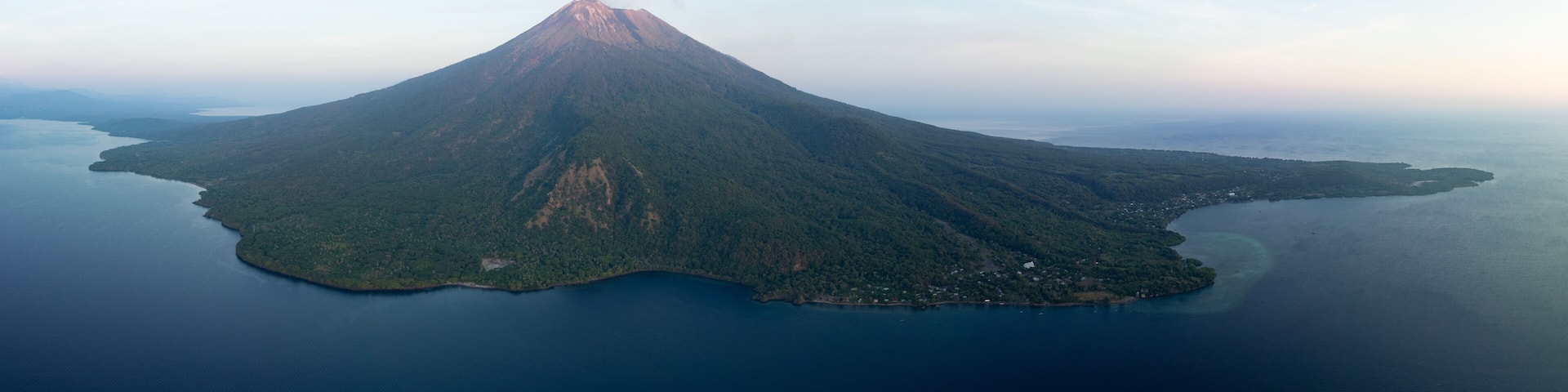 Daybreak illuminates the peak of Iliape volcano on Lembata Island in the Lesser Sunda Islands of Indonesia. This scenic volcano has been extremely active since 2024.