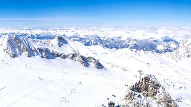 A snow-covered mountain range with clear skies.