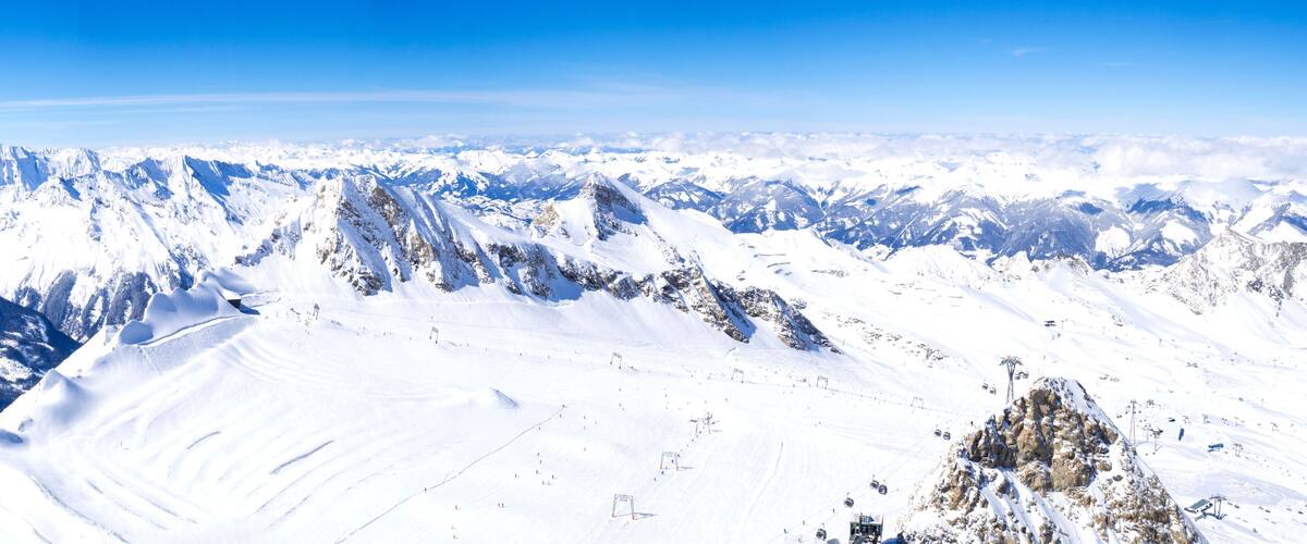 A snow-covered mountain range with clear skies.
