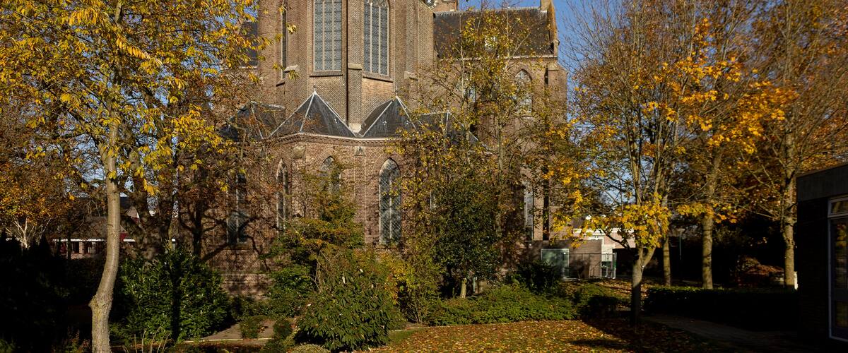 A historic church with two tall spires and a brick facade.