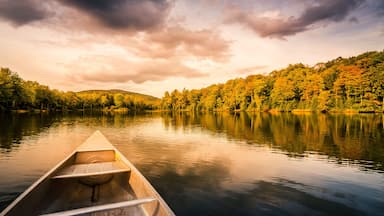Aluminum canoe on a mountain lake upstate New York. Camping. outdoors and adventure concept. Faded, vintage color post processed