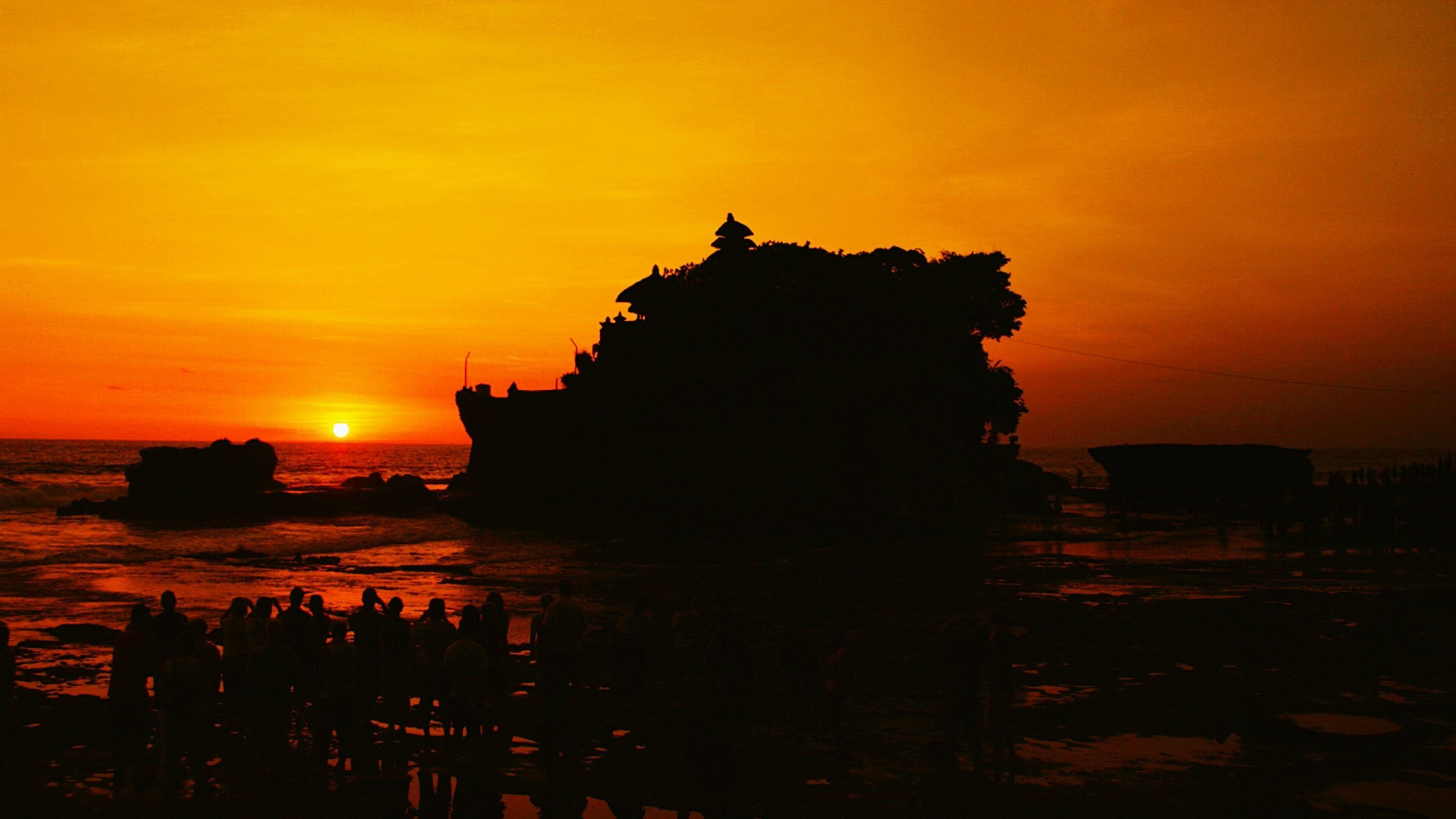 Tanah Lot which includes a sunset and general coastal views