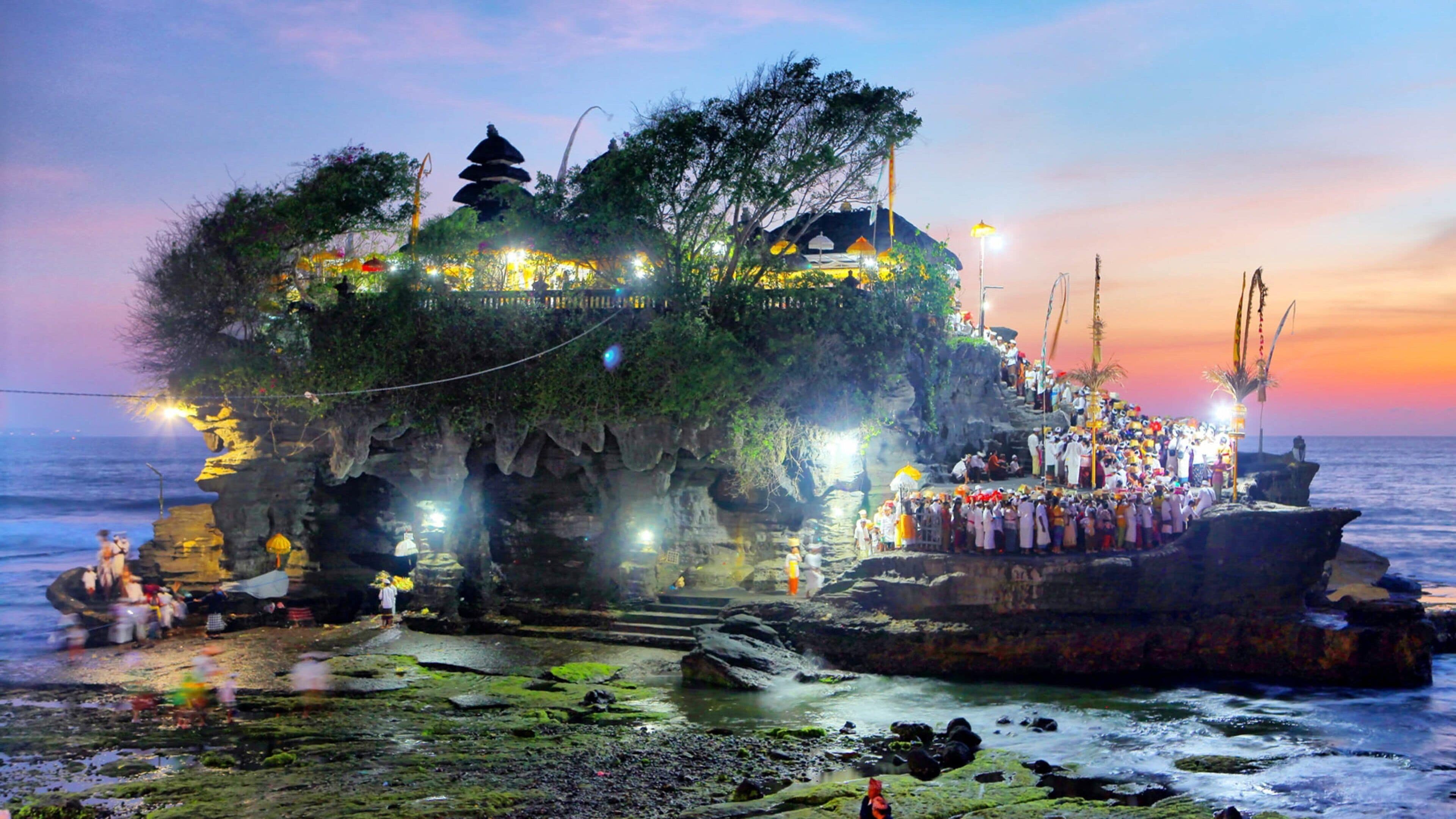 Tanah Lot featuring general coastal views, island views and a sunset