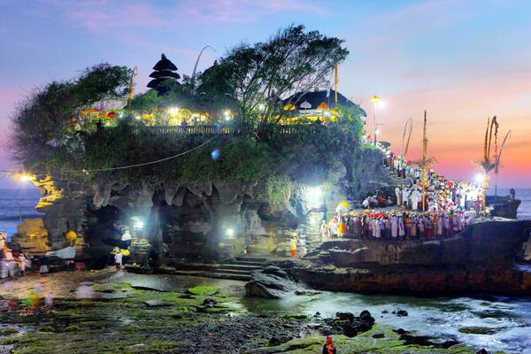 Tanah Lot featuring general coastal views, island views and a sunset