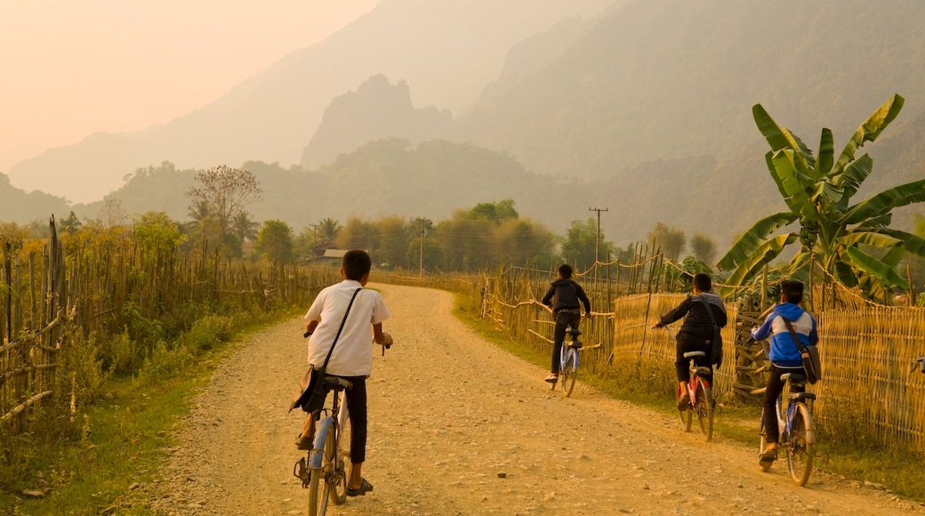 Children cycling, Sunset at limestone mountains of Vang Vieng, Laos