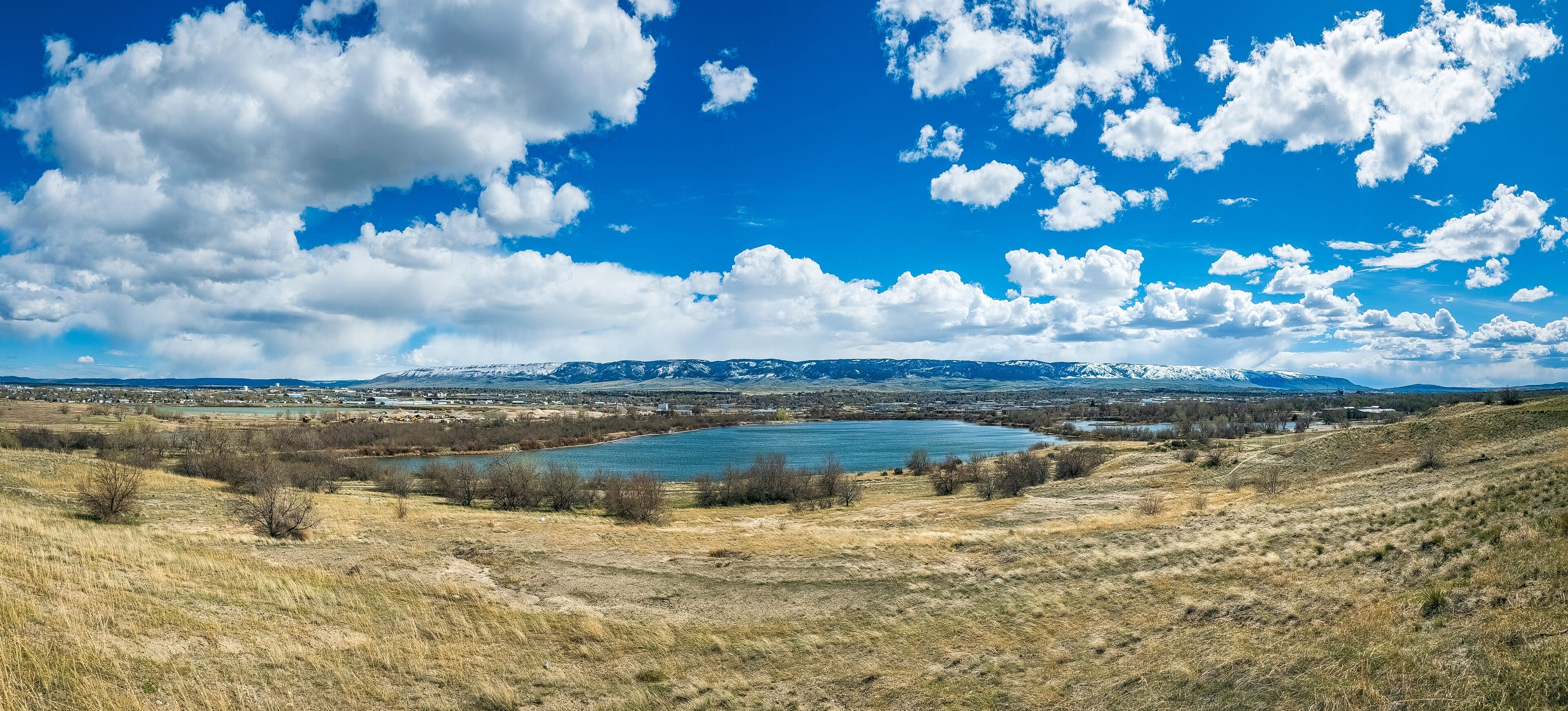 A lake surrounded by mountains and a town.