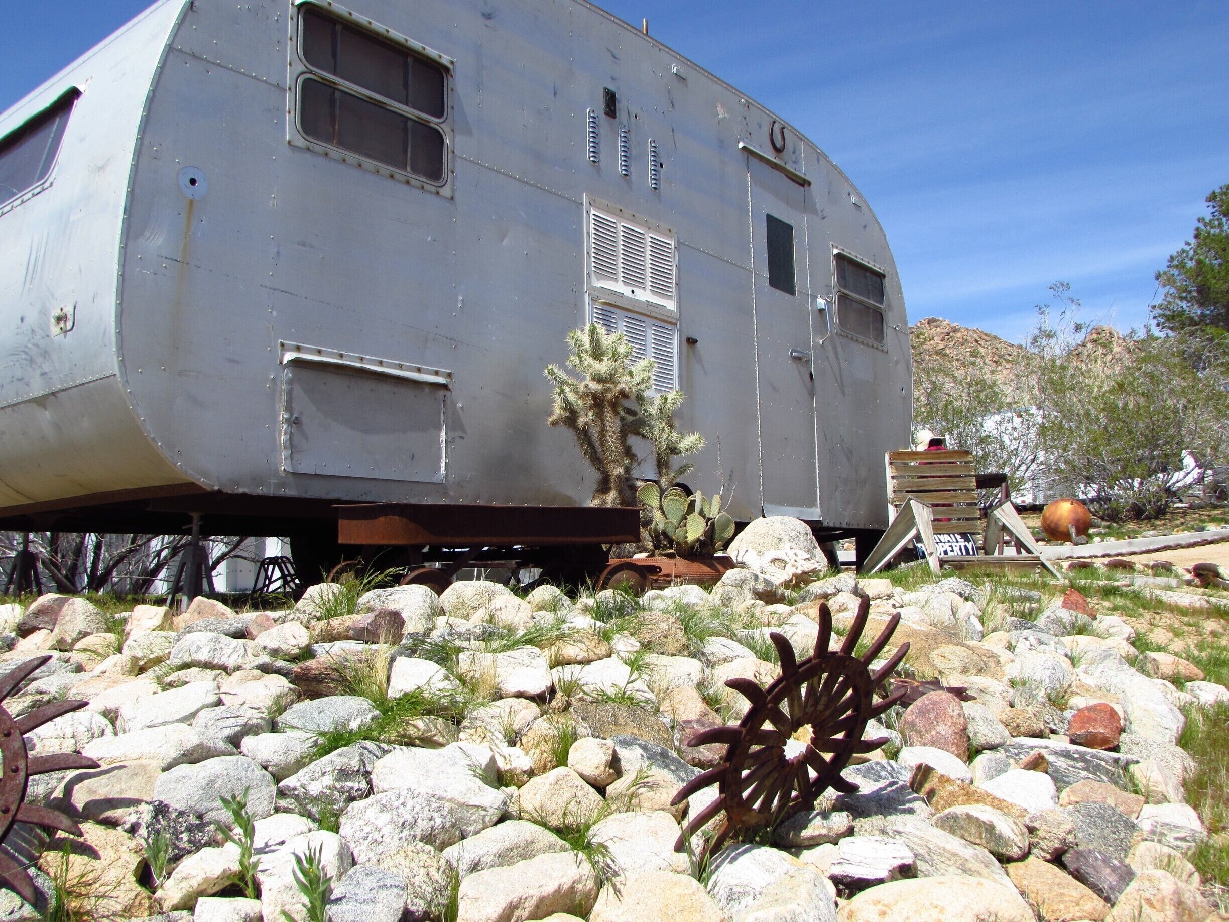 A nice, cozy looking trailer home with a cute front porch put together by the talented Bobby Furst.