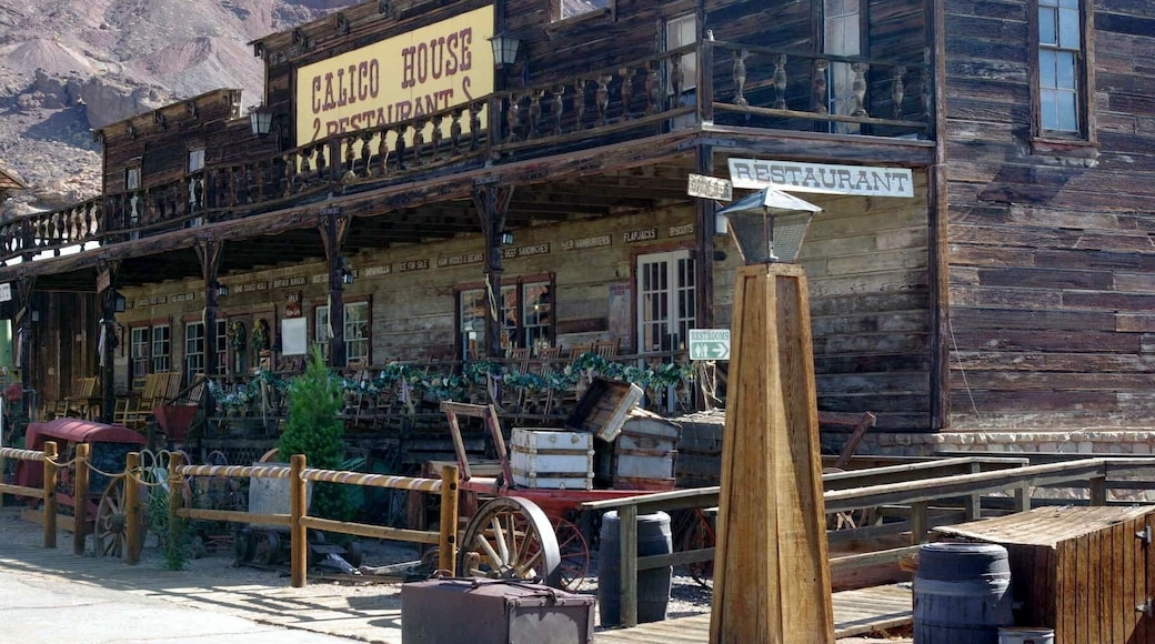 Calico is a ghost town and former mining town in San Bernardino County, California, United States. Located in the Calico Mountains of the Mojave Desert region of Southern California, it was founded in 1881 as a silver mining town, and today has been converted into a county park named Calico Ghost Town. Located off Interstate 15, it lies 3 miles (4.8 km) from Barstow and 3 miles from Yermo. Giant letters spelling CALICO can be seen on the Calico Peaks behind the ghost town from the freeway. Walter Knott purchased Calico in the 1950s, architecturally restoring all but the five remaining original buildings to look as they did in the 1880s. Calico received California Historical Landmark