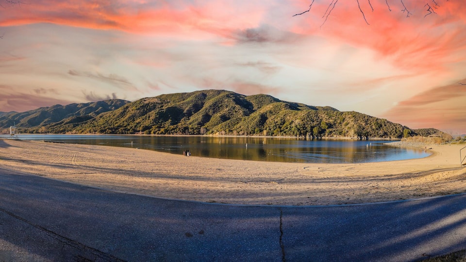 a stunning panoramic shot of the still lake water and majestic mountain ranges reflecting off the lake water at Silverwood Lake in Hesperia California USA