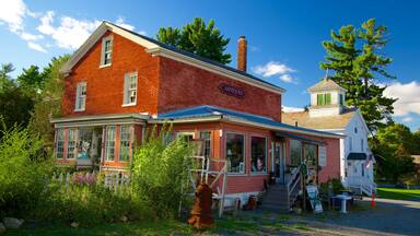A red brick building with a sign reading "Antiques" and a small white tower with a green roof.